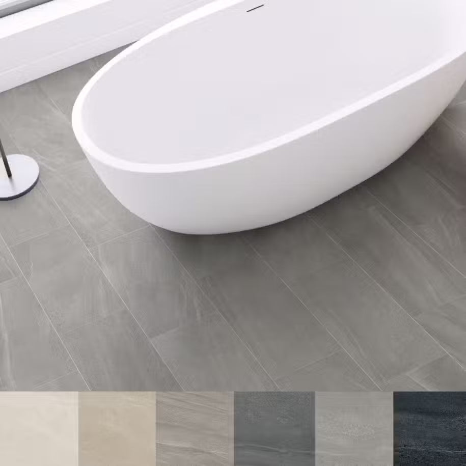 White freestanding bathtub on a gray tiled floor with color swatches below.