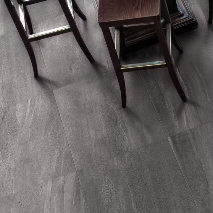 Gray vinyl flooring with wooden chairs in the background
