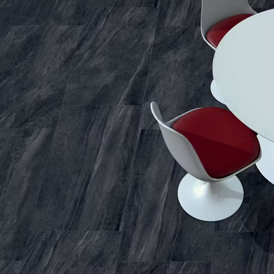 Modern chairs with red seats and white bases on a dark gray textured floor.