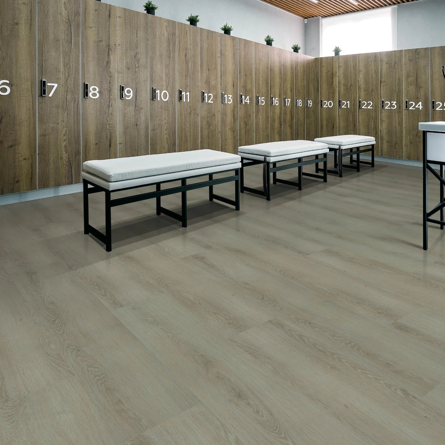 Wooden locker room with numbered lockers and white benches.