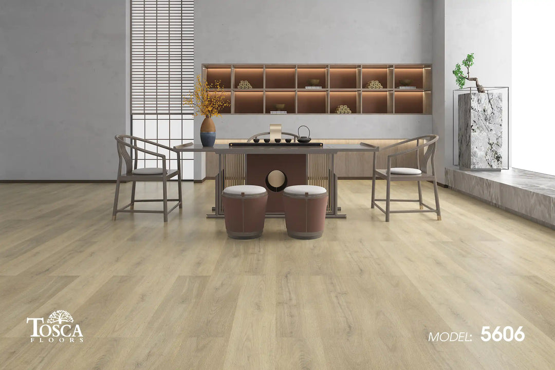 Dining room with wooden flooring, table, chairs, and shelves in the background. Tosca Floors branding visible.
