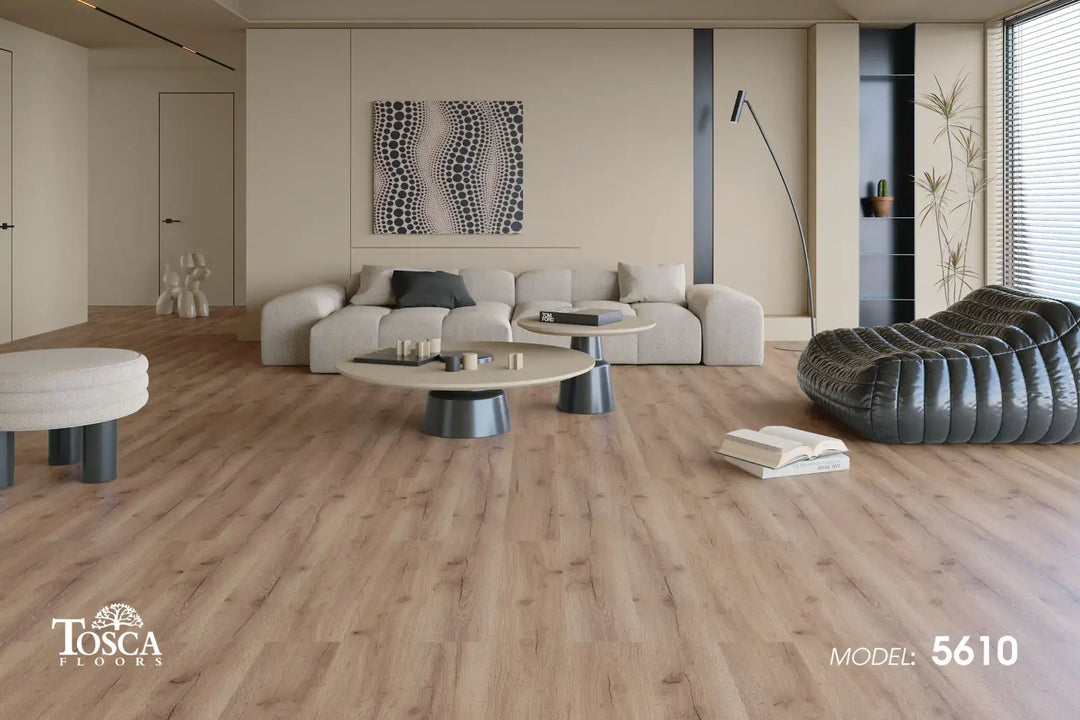 Modern living room with wooden flooring, furniture, and a Tosca Floors logo.