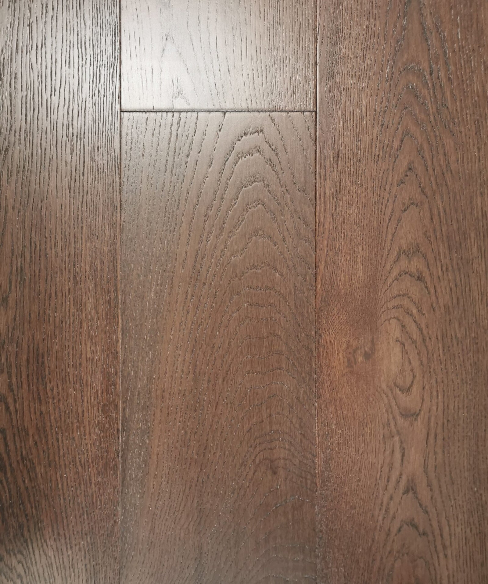 A close-up of Mocha European Oak 7.5" & 4mm Veneer layer Engineered Hardwood from Riche.