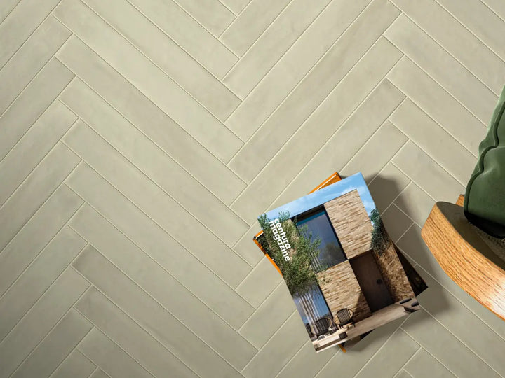 Tile sample on a floor with a herringbone pattern