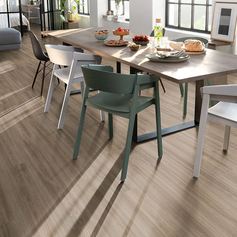 Dining area with a wooden table and chairs on a wooden floor.