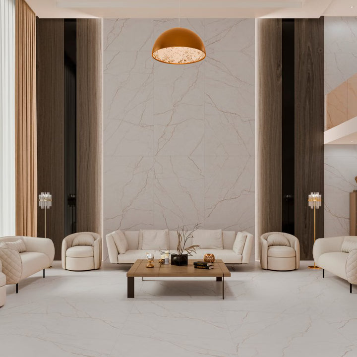 Modern living room with marble walls, beige furniture, and a coffee table.