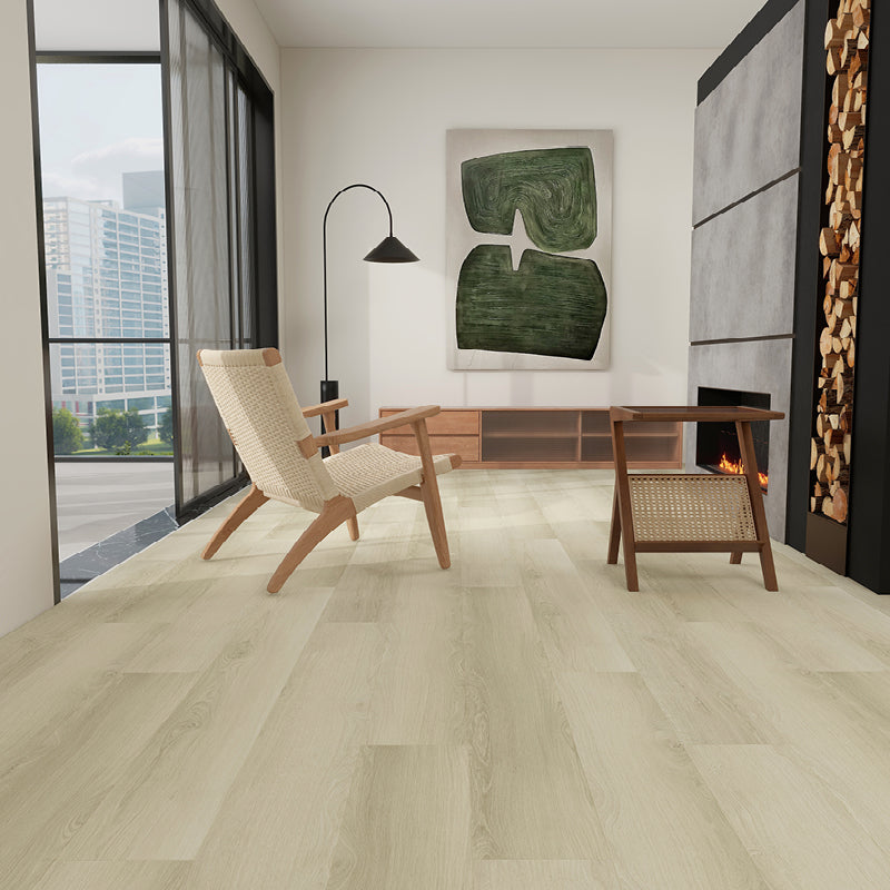 Modern living room with light wood flooring, chair, and abstract art on the wall.
