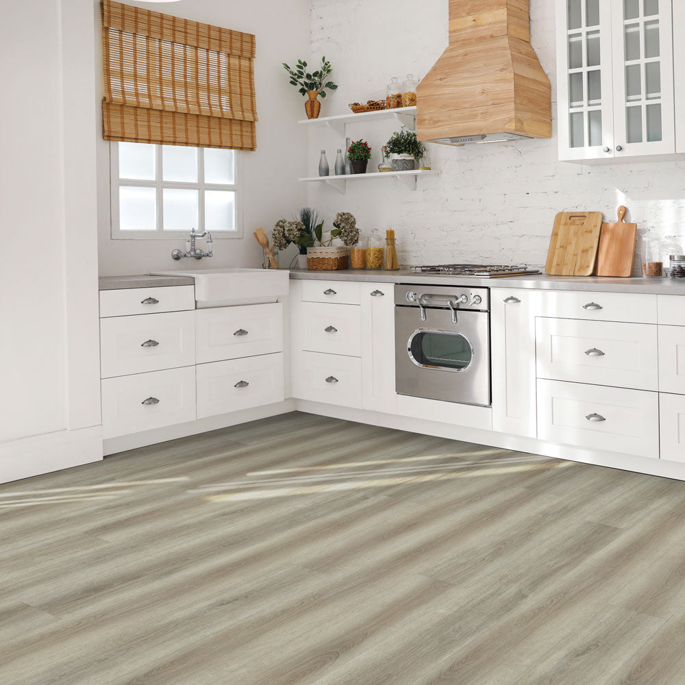 Modern kitchen with Beaulieu 8.5mm WPC vinyl flooring in Barley 6049 color. Installation services in Waterloo & Kitchener, and Canada-wide delivery available.