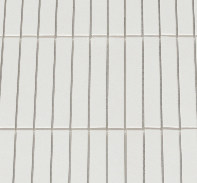 Close-up of a tiled wall with horizontal lines on a white background