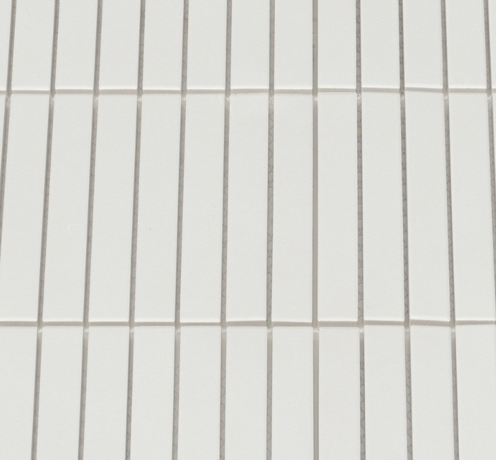 Close-up of a tiled wall with horizontal lines on a white background