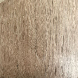 Close-up image of laminate flooring with a wood-like pattern.