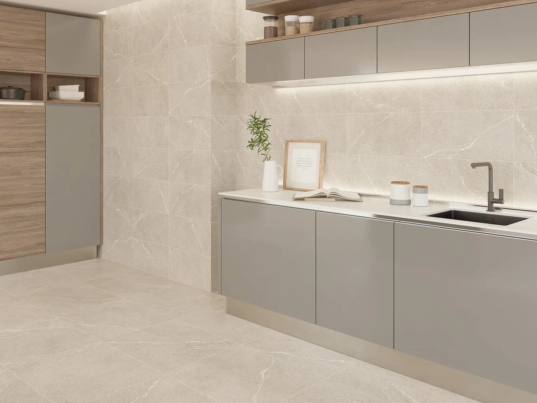 Modern kitchen with gray cabinets, marble countertop, and light wood accents.