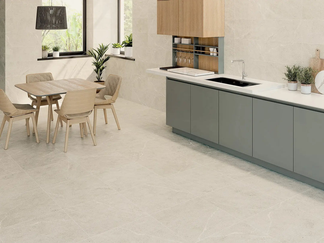 Modern kitchen with gray cabinets, white countertops, and a dining area.