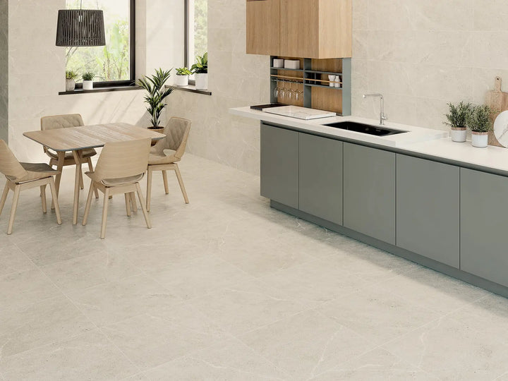 Modern kitchen with gray cabinets, white countertops, and a dining area.