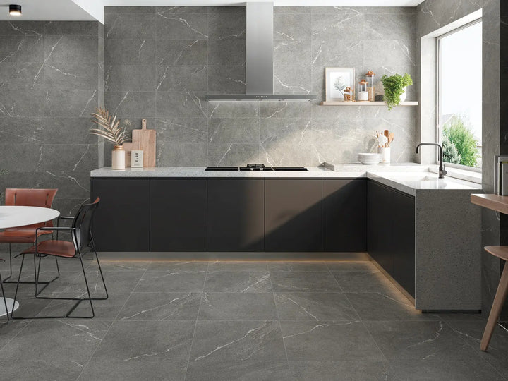 Modern kitchen with dark gray tiles and black appliances