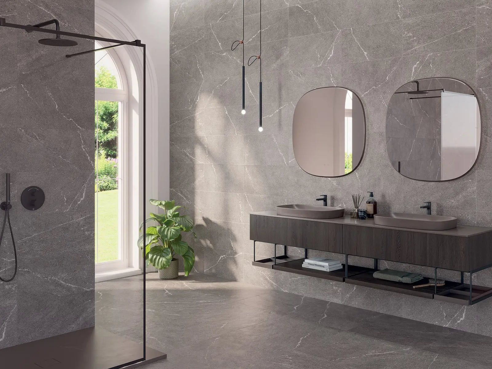 Modern bathroom with gray marble walls, a double sink vanity, and a shower area.