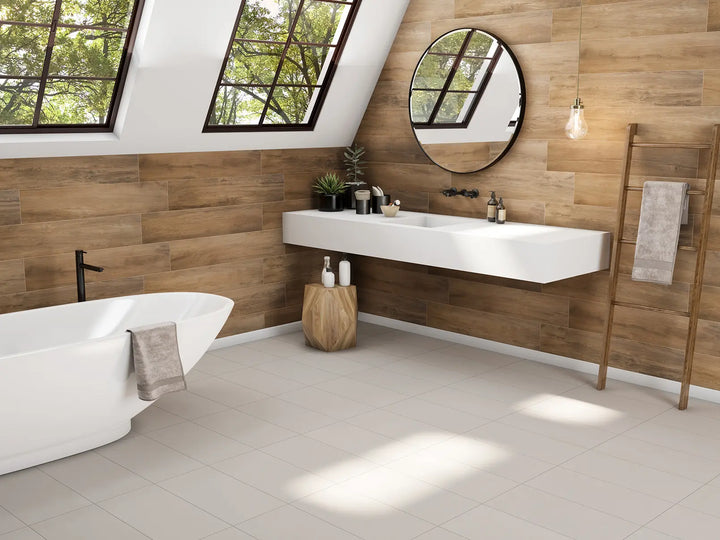 Modern bathroom with wooden walls, white sink, and bathtub.