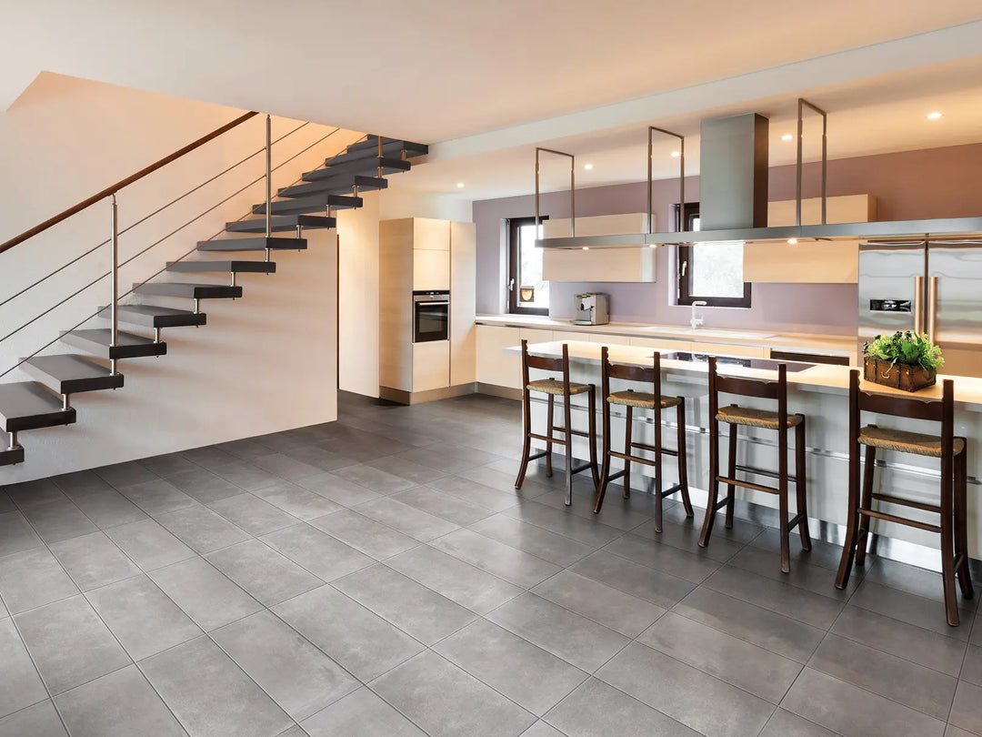 Modern kitchen with a staircase and tiled floor