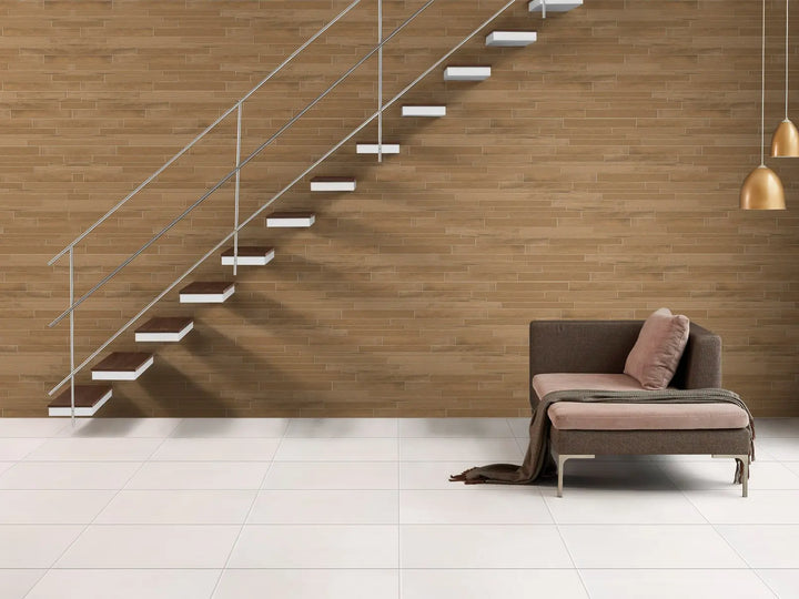 Modern living room with a wooden wall, floating staircase, and a sofa.
