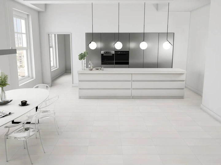 Modern kitchen with white cabinets, stainless steel appliances, and a dining area.
