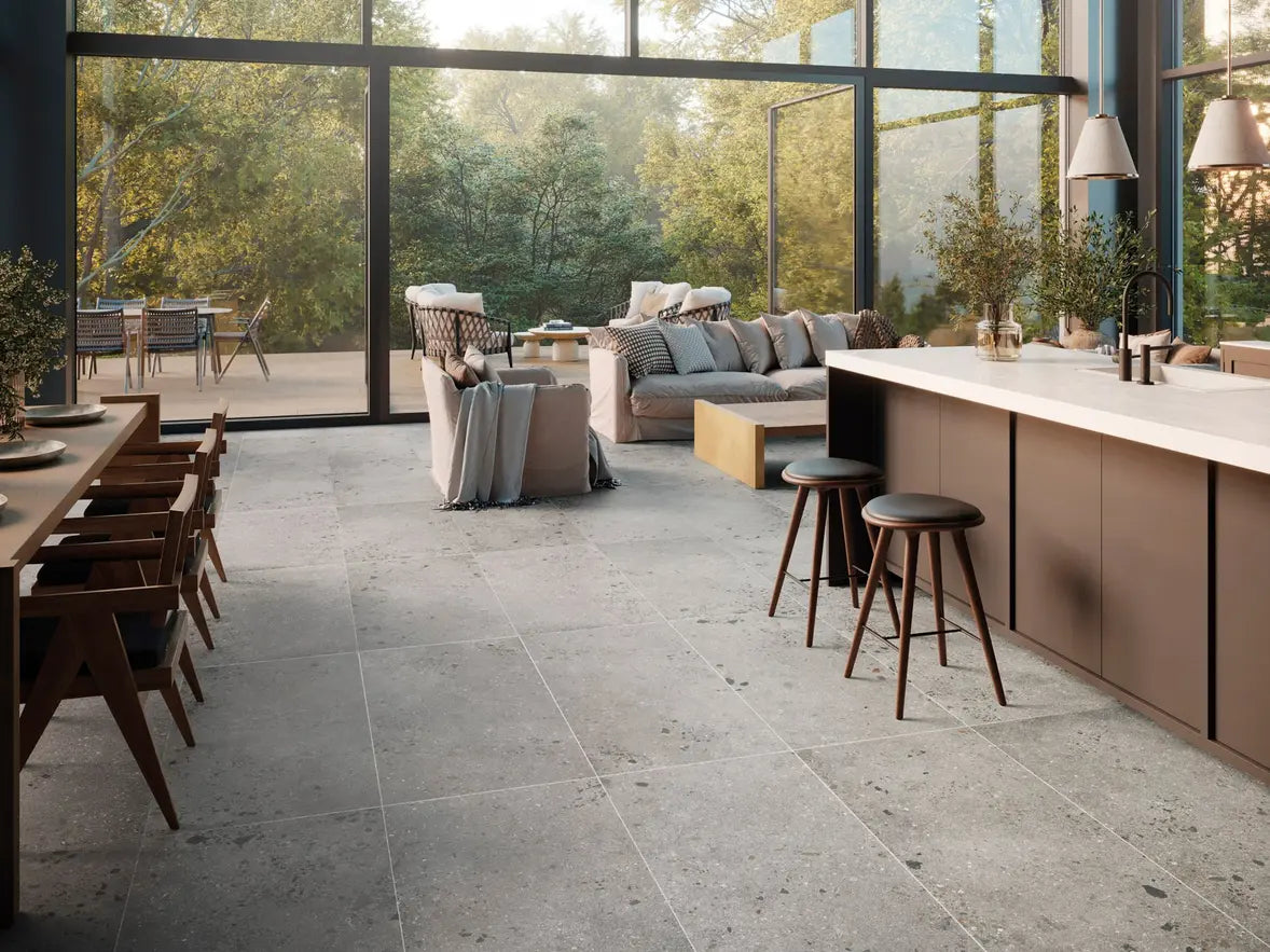 Modern kitchen and living area with large windows, neutral color palette, and natural light.