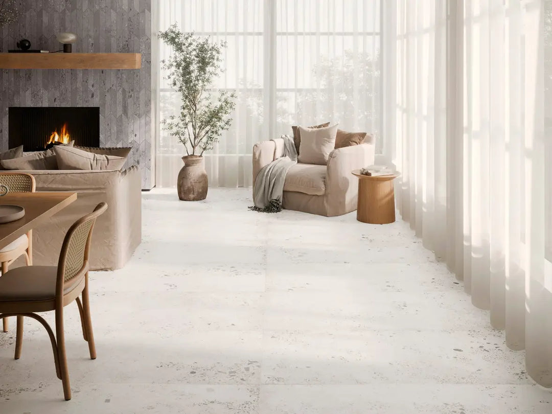 Modern living room with a fireplace, sofa, and dining table.
