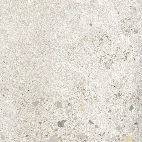 Close-up of a textured concrete surface with small stones and chips.