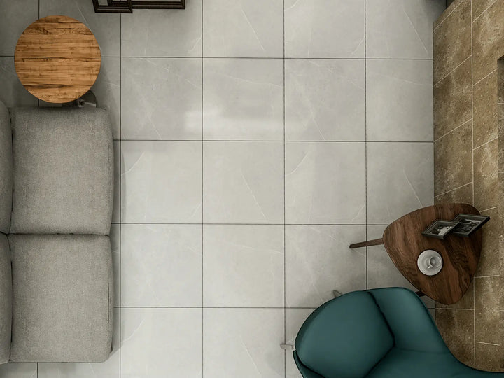Top-down view of a living room with a gray sofa, green chair, and wooden side table.