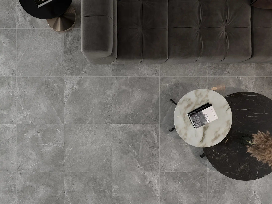 Gray tiled floor with a modern sofa and side table.