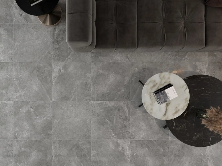 Gray tiled floor with a modern sofa and side table.