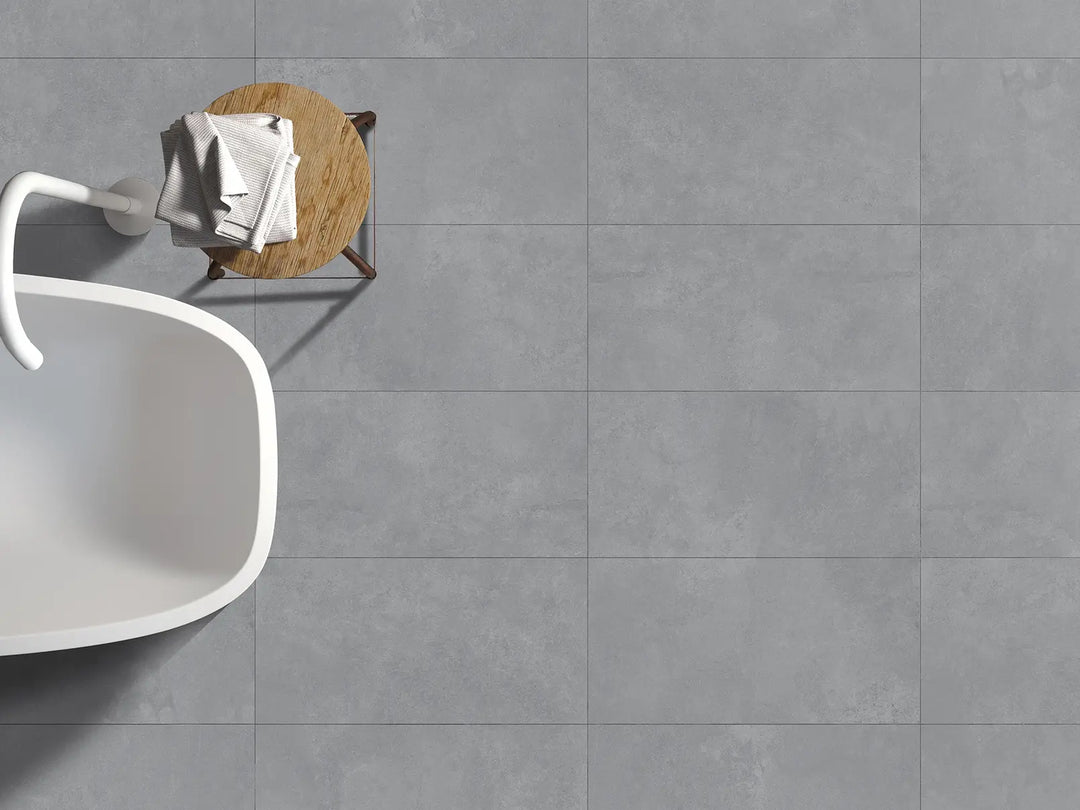 Gray tiled floor with a white chair and wooden table in the corner.