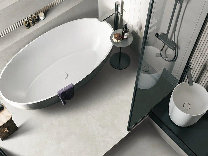 Modern bathroom with freestanding bathtub, glass shower enclosure, and sink.