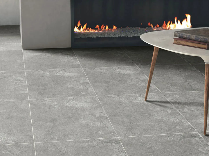 Gray tiled floor with a modern fireplace and coffee table in the background