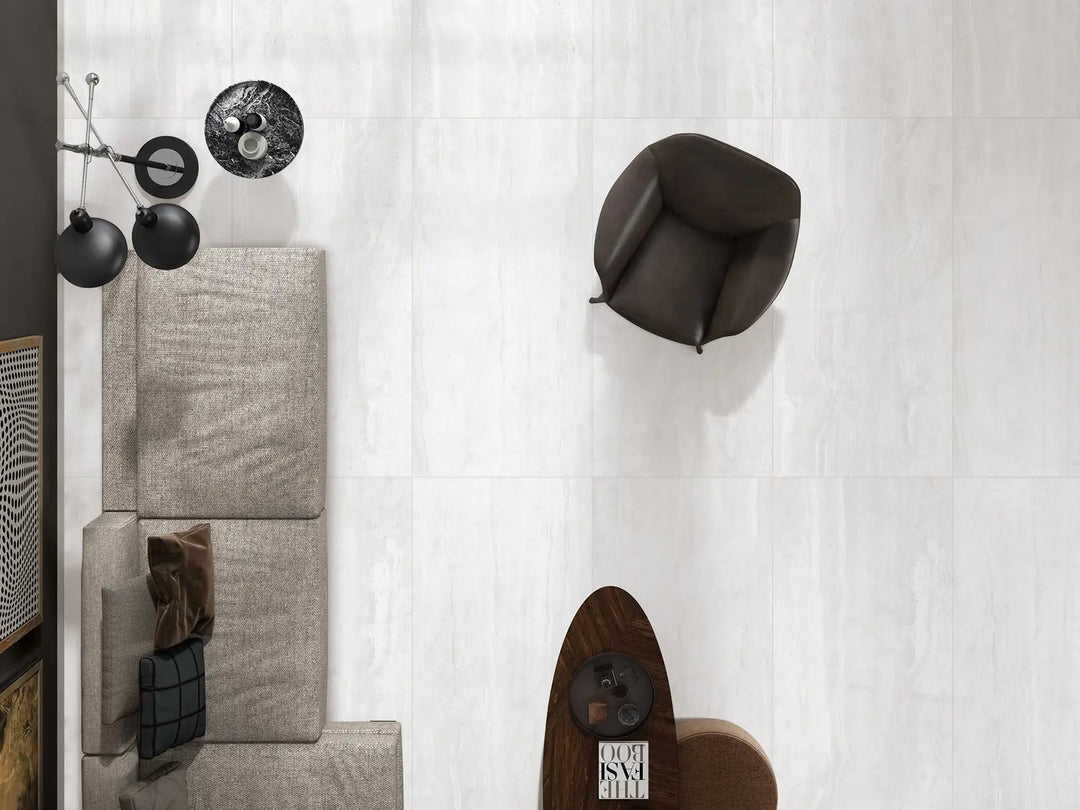 Modern wall-mounted coat rack with various hooks on a white wall.