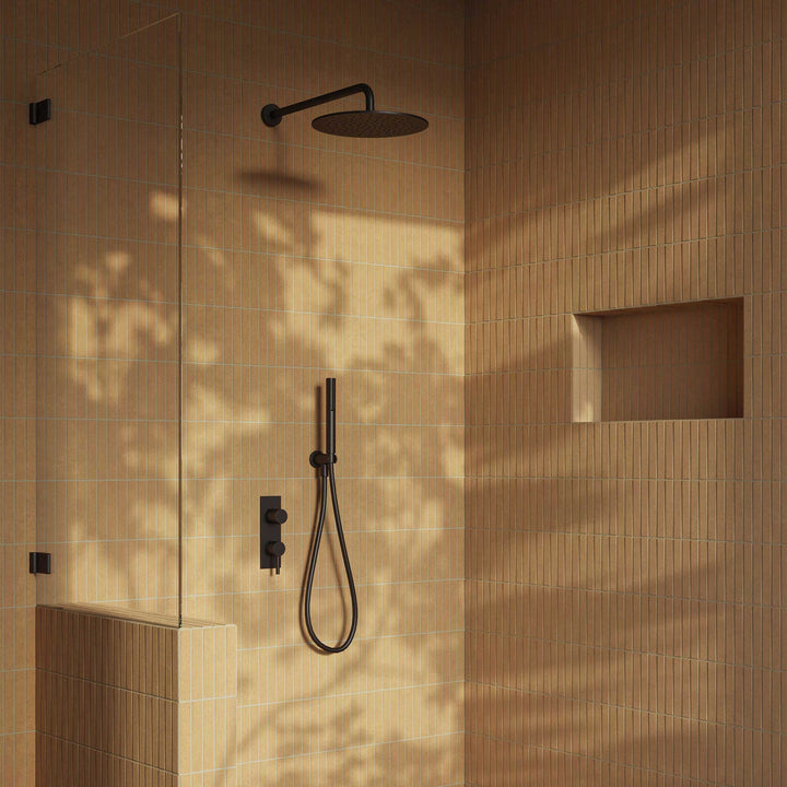 Modern shower setup with black fixtures on a beige tiled wall