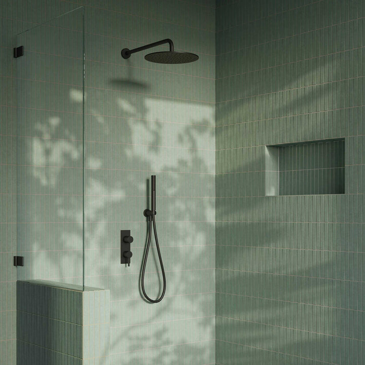 Modern shower setup with black fixtures on a tiled wall