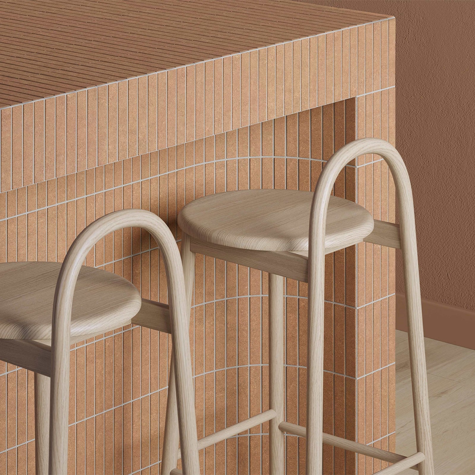 Two bar stools with beige seats and frames against a tiled wall.