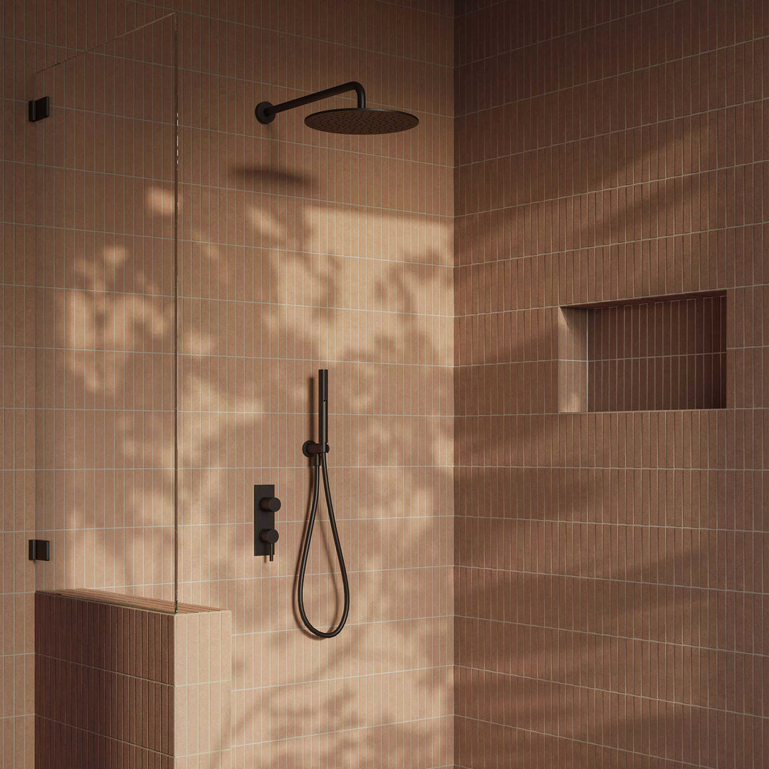 Modern shower setup with black fixtures in a tiled bathroom