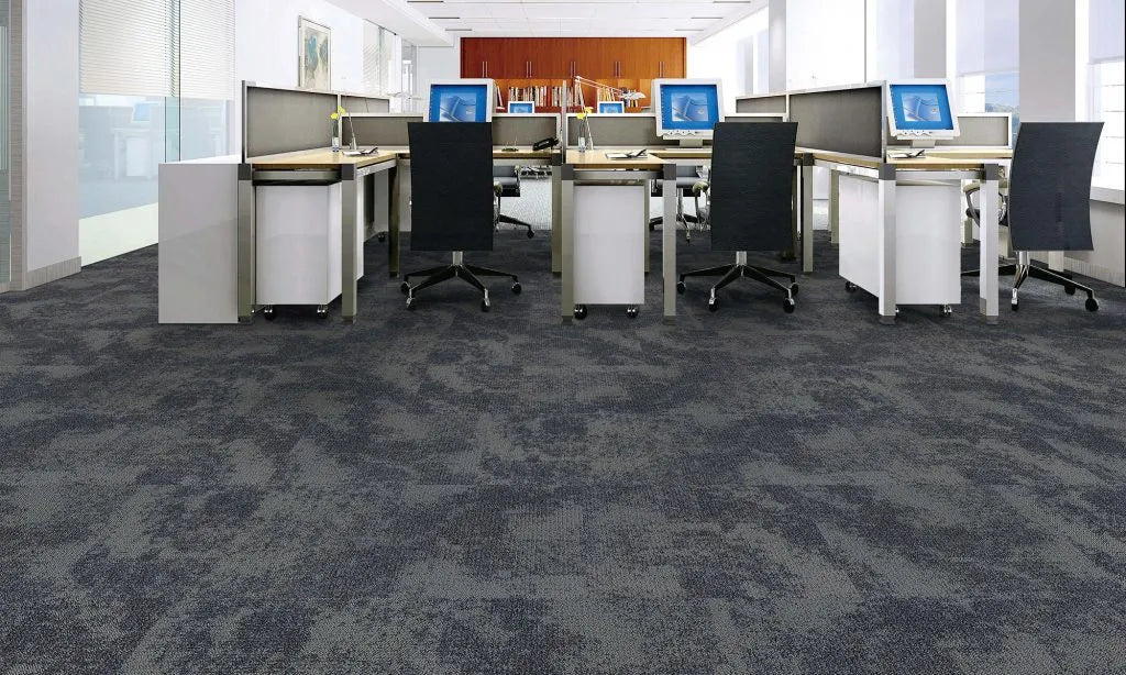 Modern office with multiple workstations, chairs, and computer monitors.