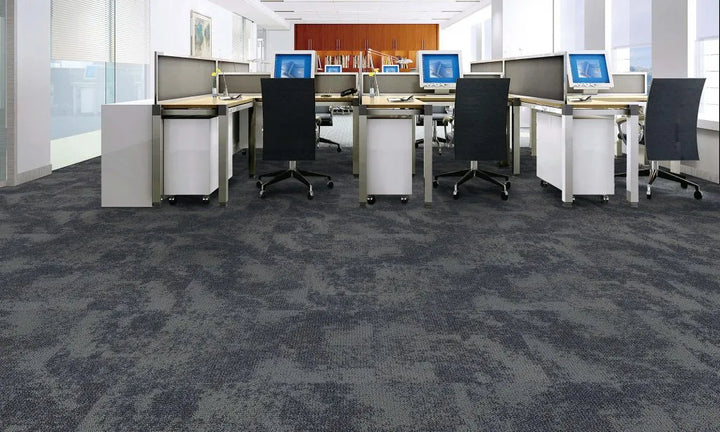 Modern office with multiple workstations, chairs, and computer monitors.