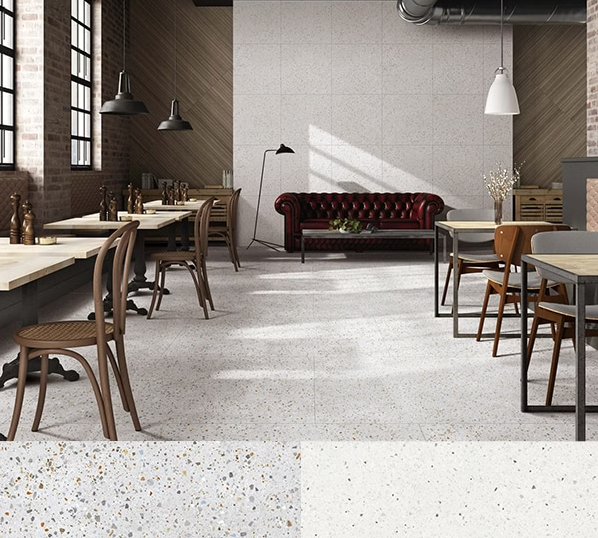 A room with wooden flooring featuring a grey and white terrazzo pattern.