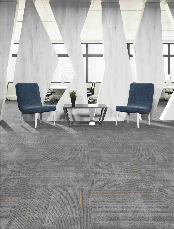 Modern office interior with gray carpet tiles, blue chairs, and large windows.