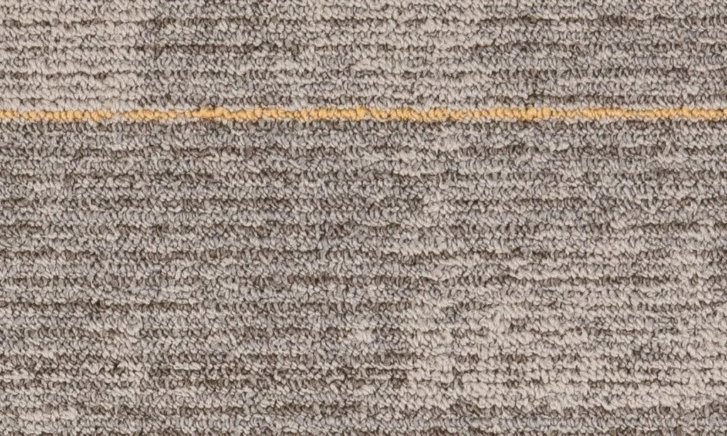 Close-up of a textured brown carpet with a gold line