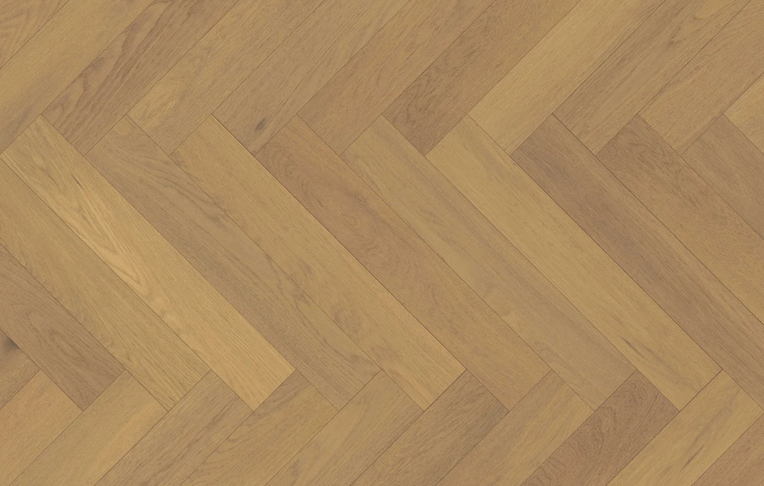 Close-up of Dusken Veil engineered hardwood from Fuzion's Velvet Grove Herringbone collection. Available at Advanced Flooring Waterloo.