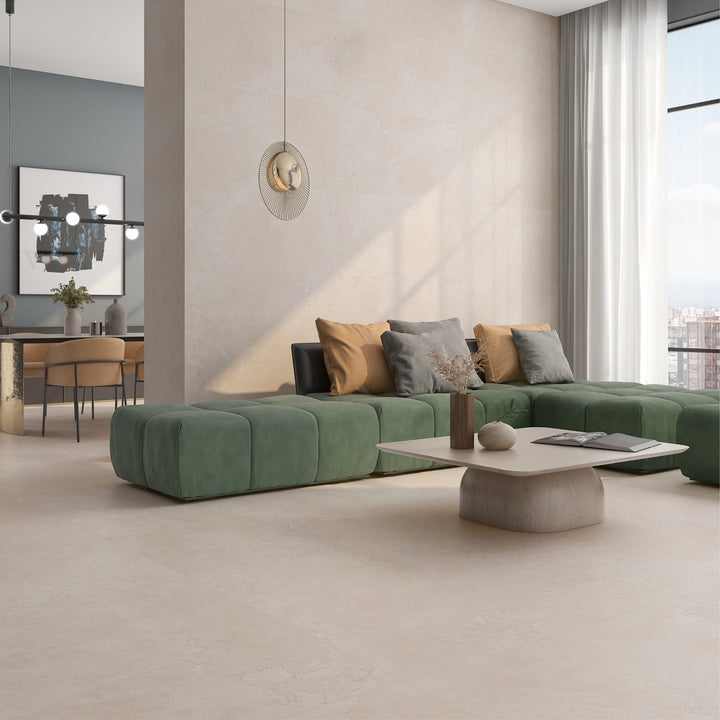 Modern living room with a green sectional sofa, coffee table, and decorative items.