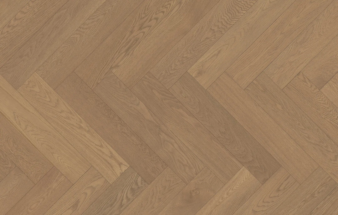 Close-up of Ember Cloak engineered hardwood from Fuzion's Velvet Grove Herringbone collection. Available at Advanced Flooring Waterloo.