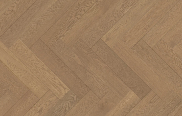 Close-up of Ember Cloak engineered hardwood from Fuzion's Velvet Grove Herringbone collection. Available at Advanced Flooring Waterloo.
