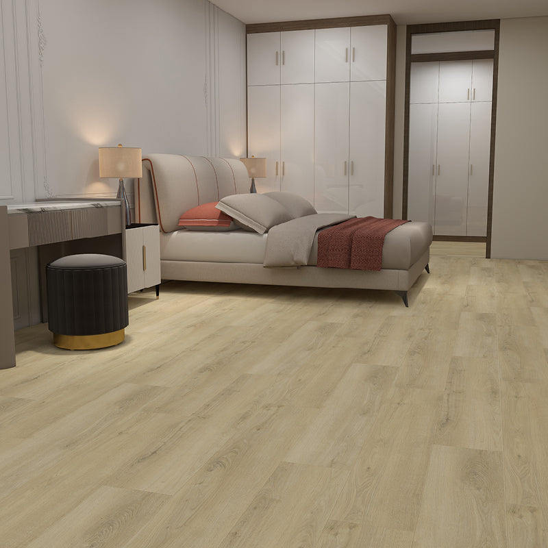 Modern bedroom with a bed, wardrobe, and desk on a wooden floor.