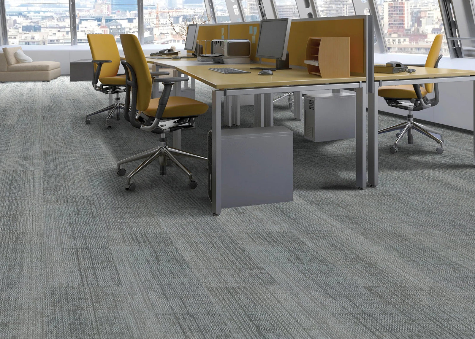 Modern office space with gray carpet, desks, and chairs.