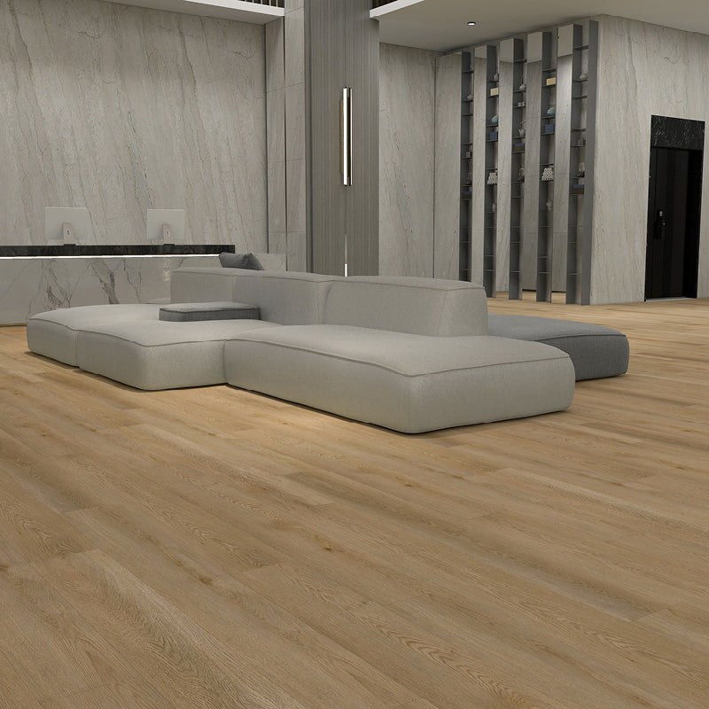 Modern gray sectional sofa in a room with wooden flooring and a neutral color palette.